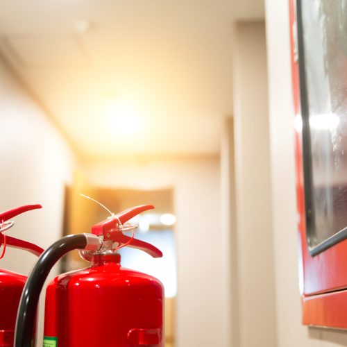 Red fire extinguisher tank in the building.